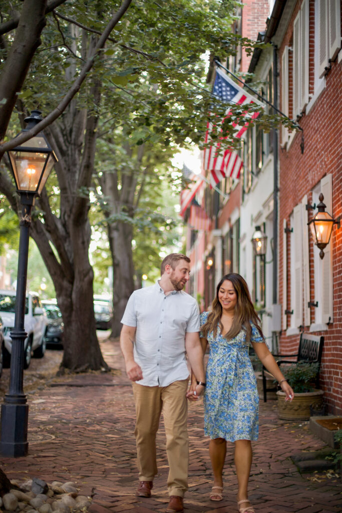 A man and woman walk down Prince Street in Old Town Alexandria